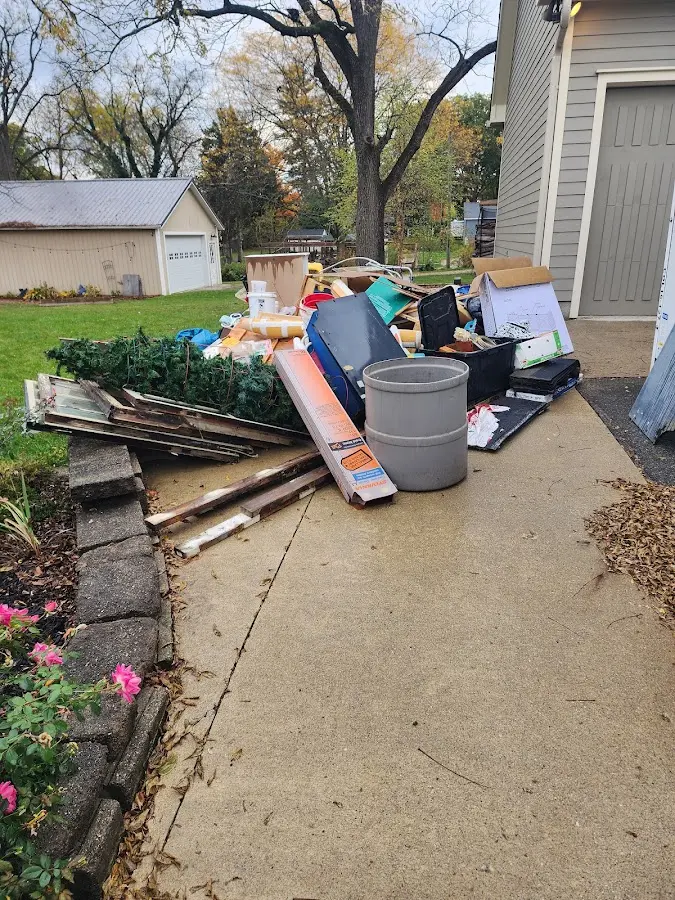 Dumpster being loaded with debris for Commercial Dumpster Rental in Williamsburg